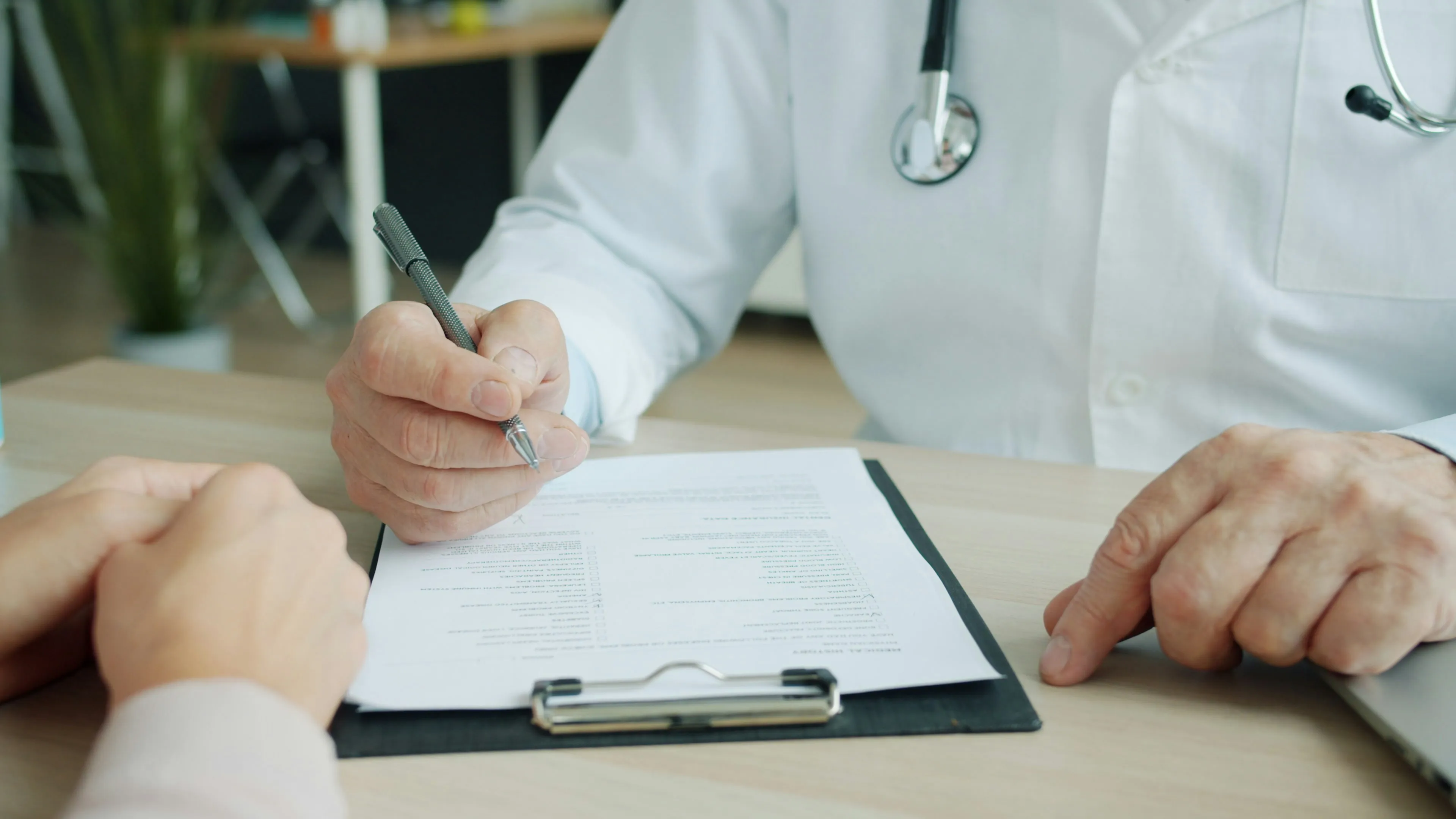 Doctor discussing a health assessment, representing preventative platform and occupational health integration